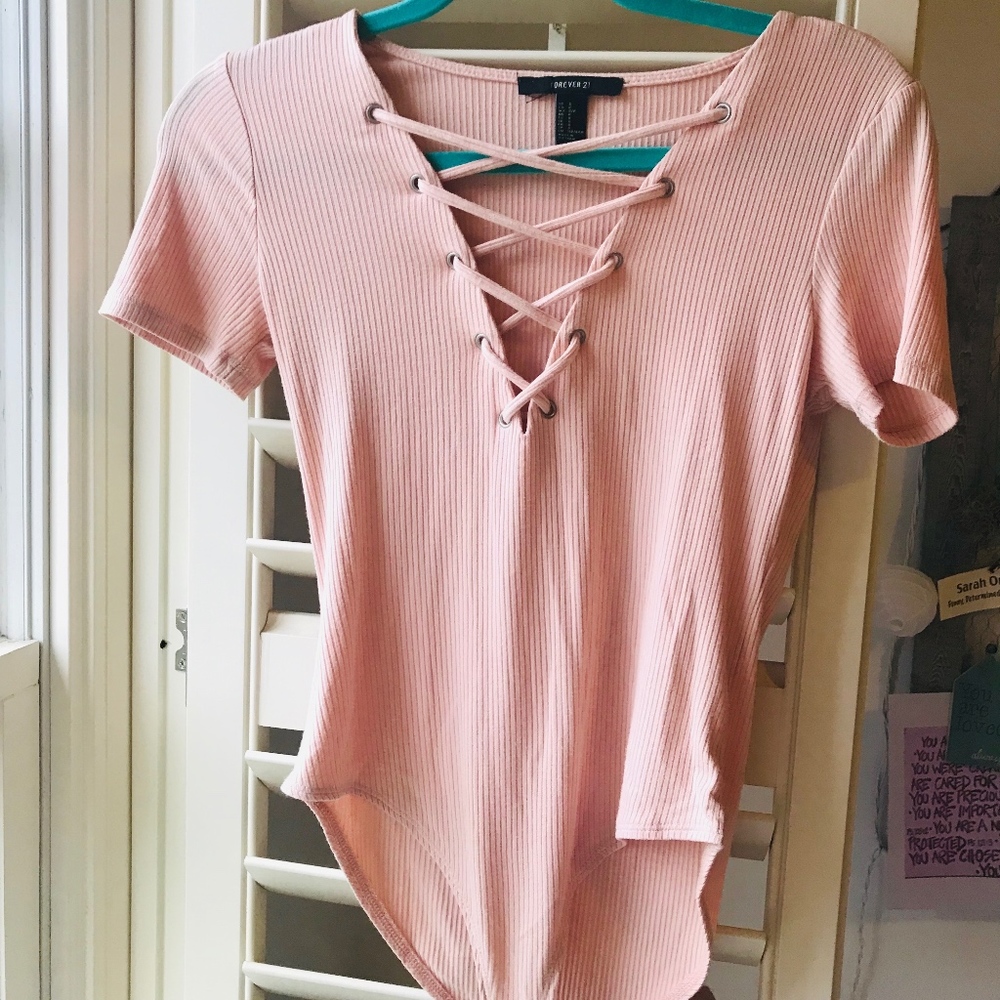 light pink laced up short sleeved body suit